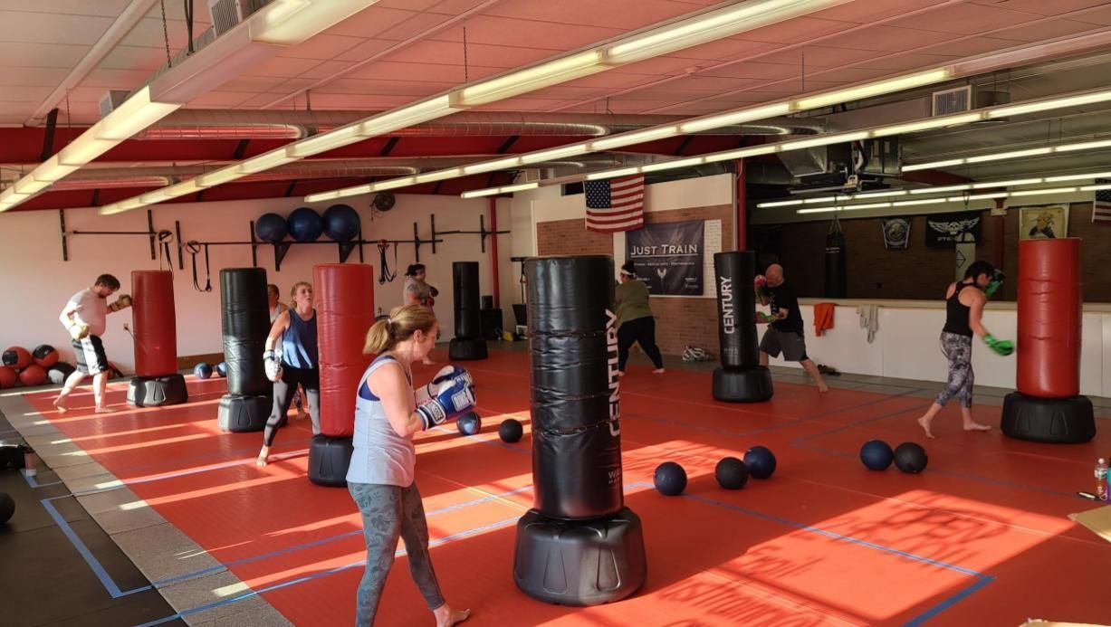 a man and a woman are boxing in a gym