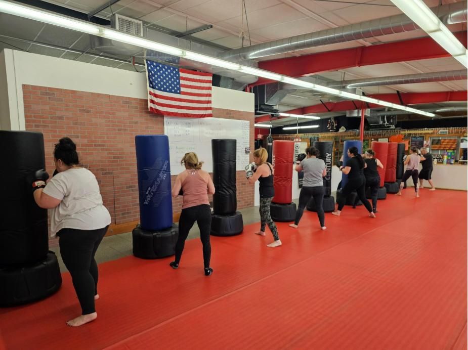 a group of people are practicing martial arts in a gym