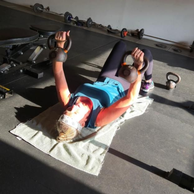 a group of people are doing exercises in a gym