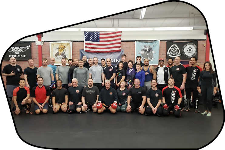 a group of people are posing for a picture in a gym .