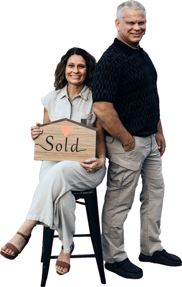 A man and a woman are standing back to back and smiling.