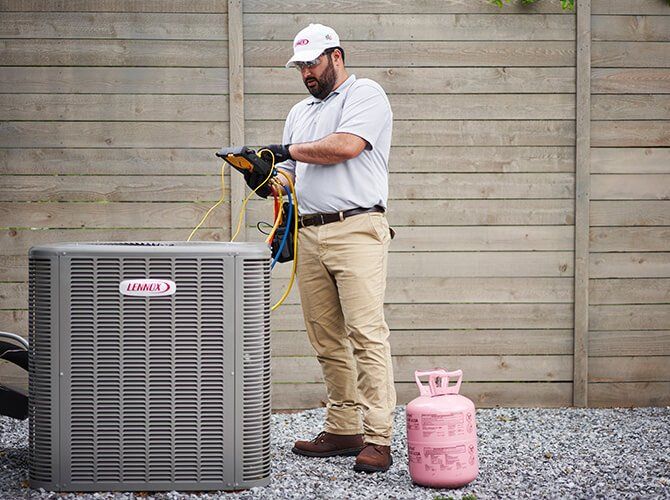 Man Outside Fixing Lennox Aircon — Bossier City, LA — Brooks Heating & Air Conditioning
