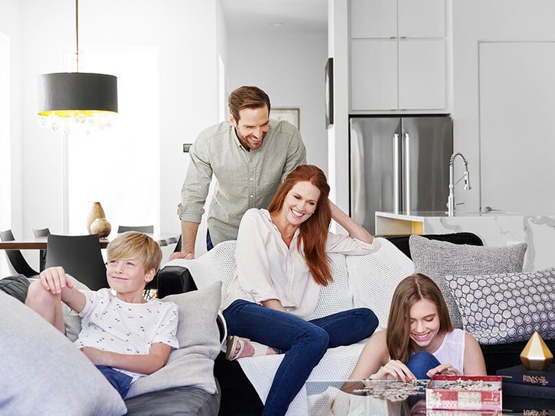 Happy Family In Living Area — Bossier City, LA — Brooks Heating & Air Conditioning