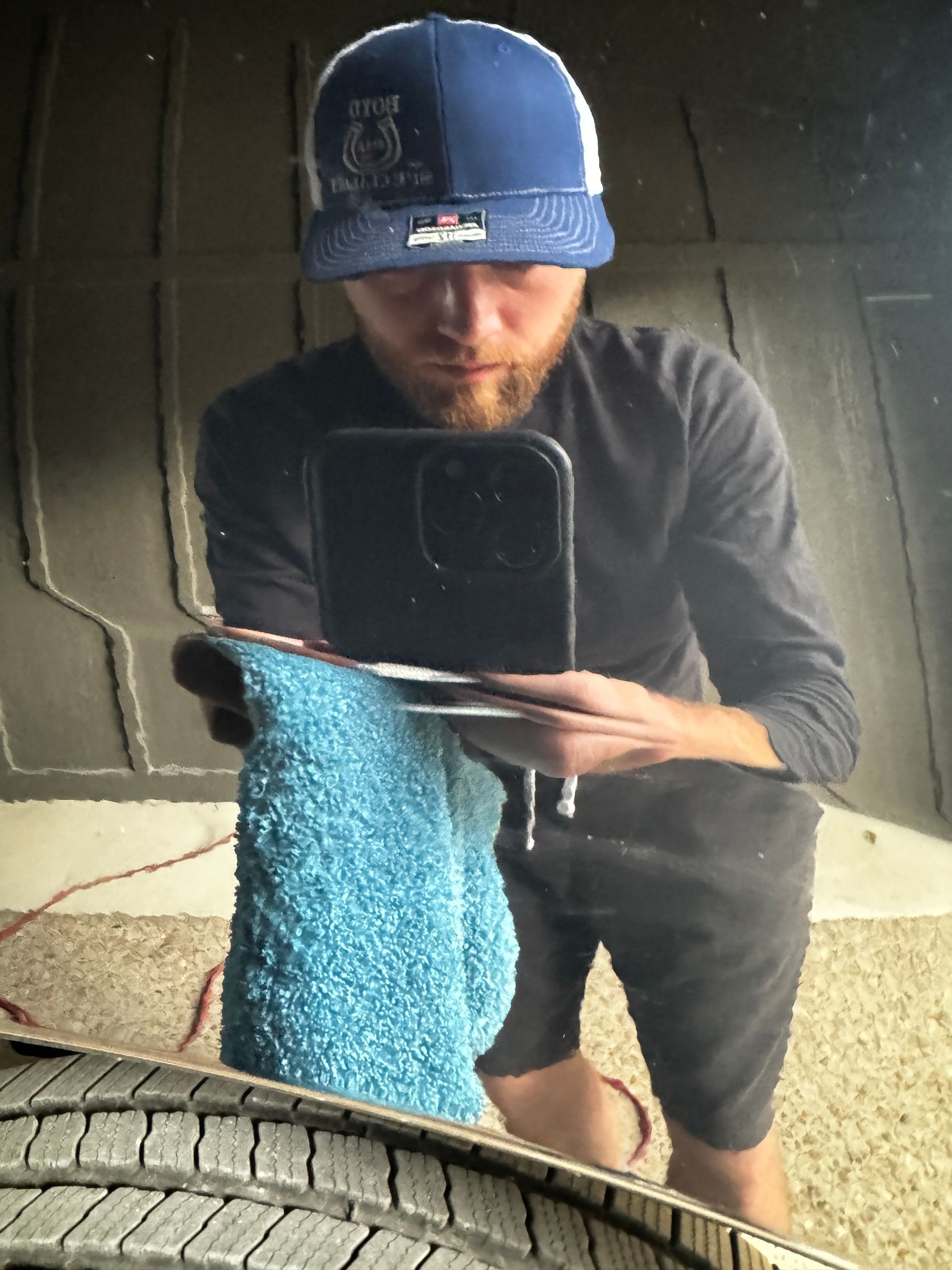Joseph Dunn taking a selfie in the reflection of car paint to show off the crystal clear finish after a 1 step polish. 