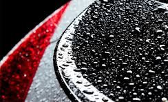 Black car paint covered in water stains that need to be removed.