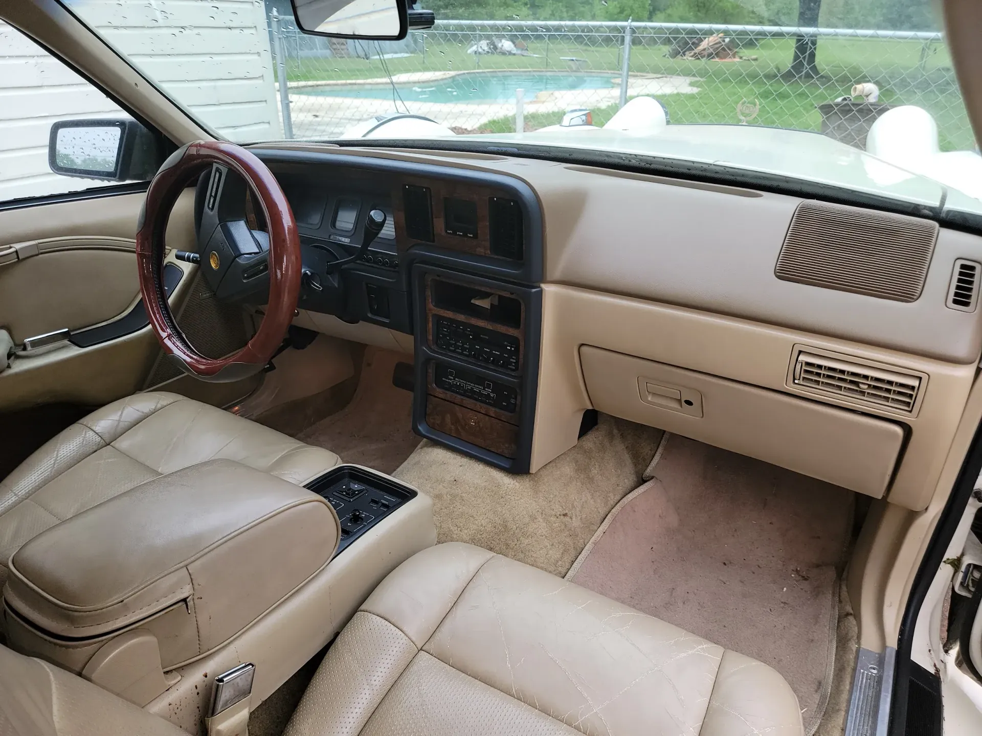 1980 CMC Classic Tiffany coupe, interior view with wood trim and tan leather seats, looking like new after a detail.