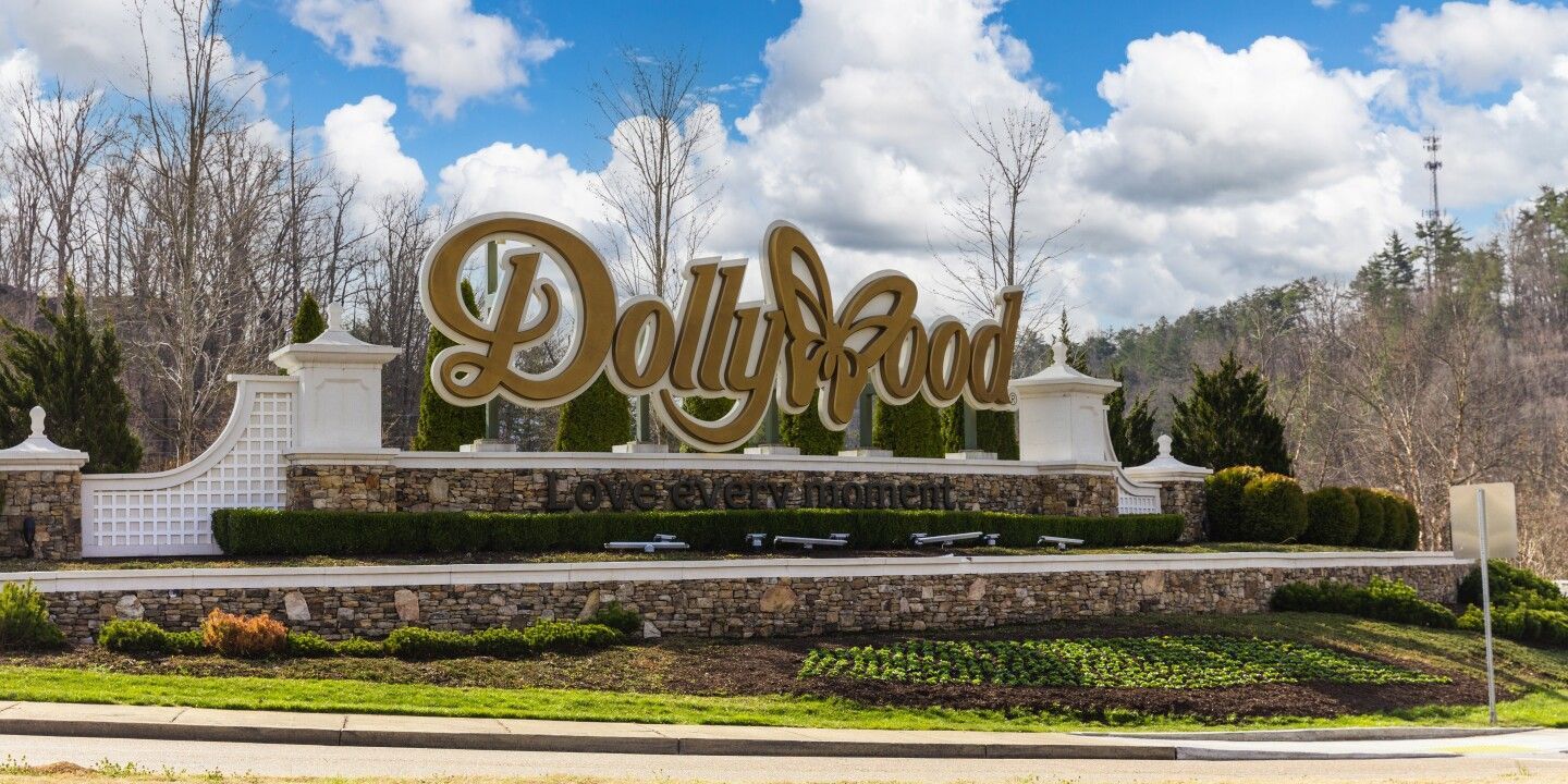 A stone entrance sign with gold lettering that reads 