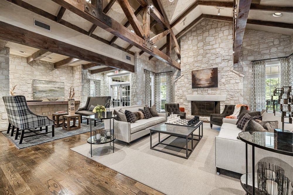 a clubhouse room filled with furniture and a fireplace at Marquis at Deerfield in San Antonio, TX.