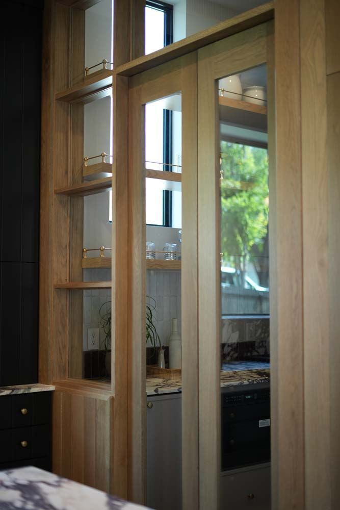 A kitchen with sliding glass doors and shelves.