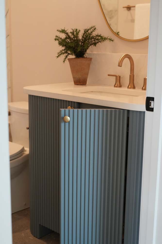 A bathroom with a sink , toilet and mirror.
