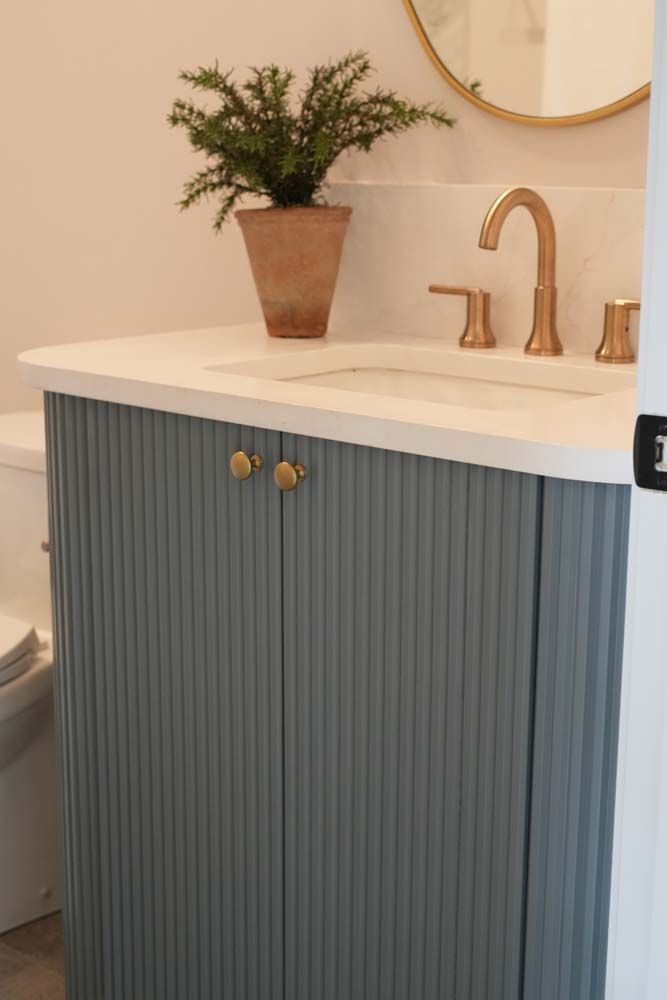 A bathroom with a sink , toilet and mirror.
