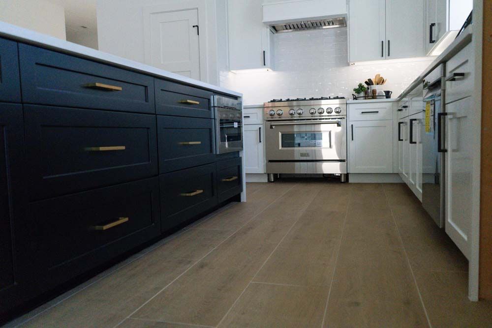 A kitchen with black cabinets and stainless steel appliances