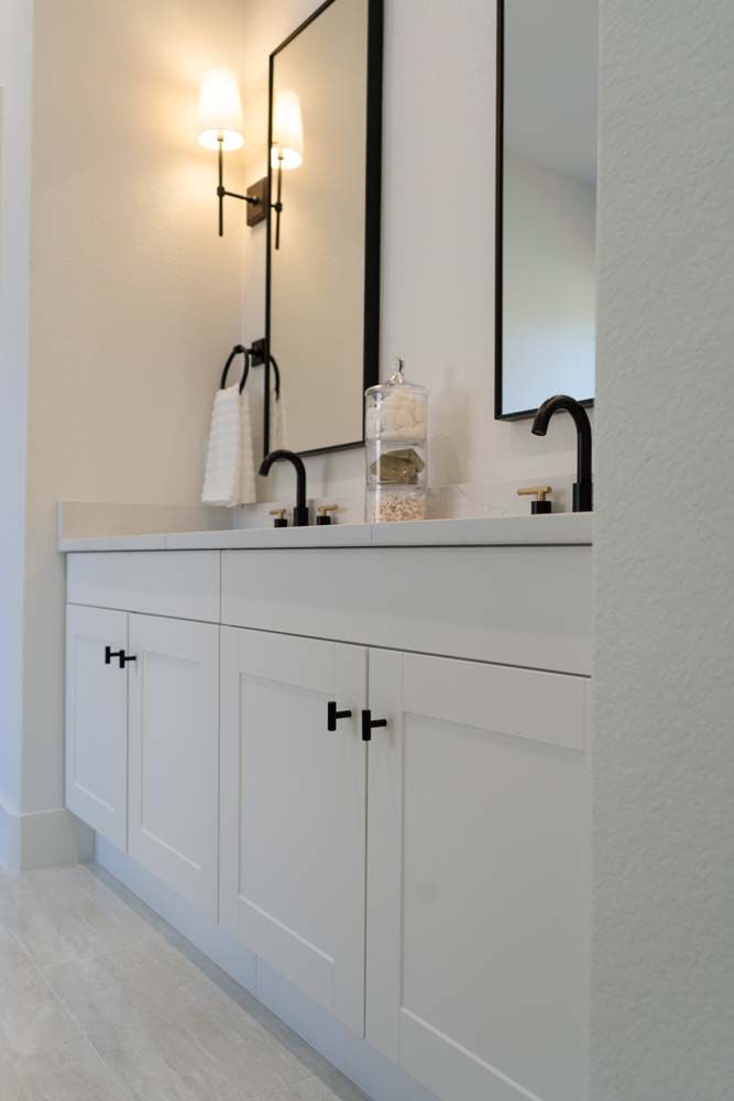 A bathroom with two sinks and a mirror.