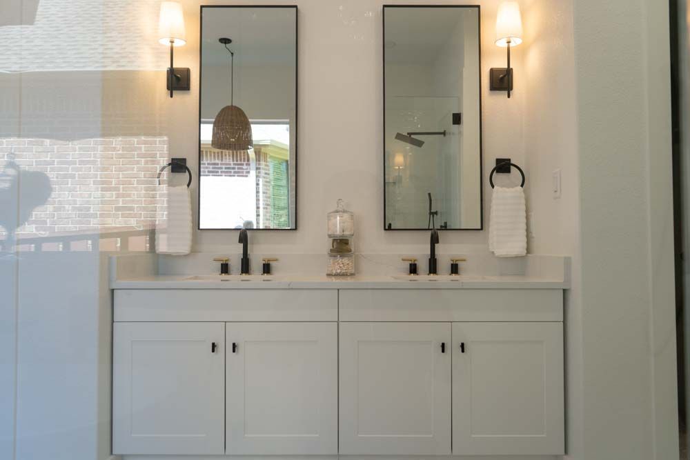 A bathroom with two sinks and two mirrors.
