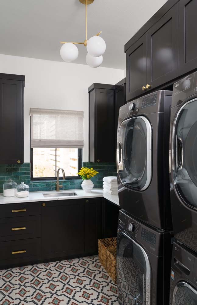 A laundry room with a washer and dryer stacked on top of each other.