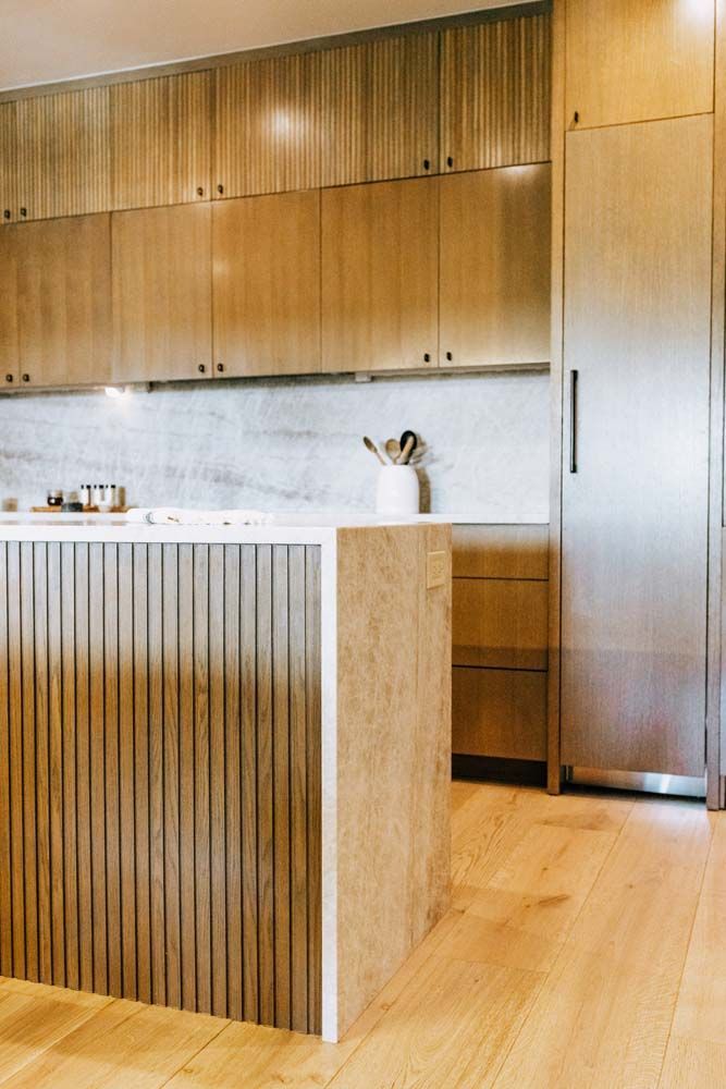 A kitchen with wooden cabinets and stainless steel appliances
