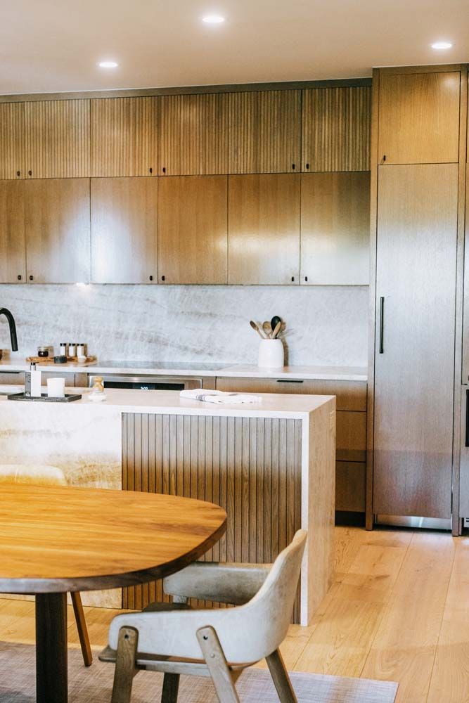 A kitchen with a table and chairs in it