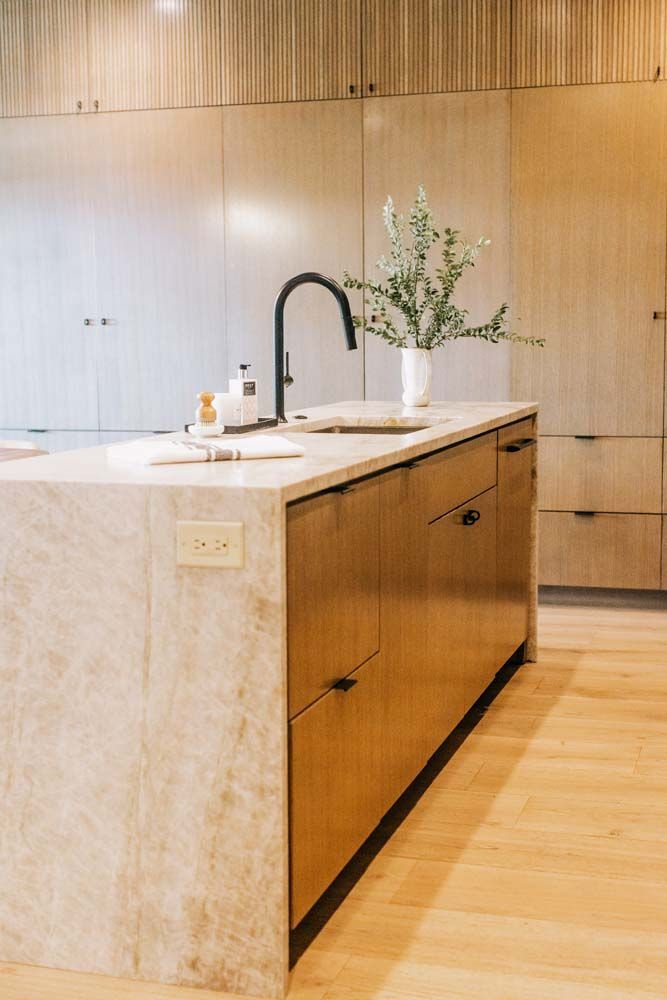 A kitchen with a large island and a sink.