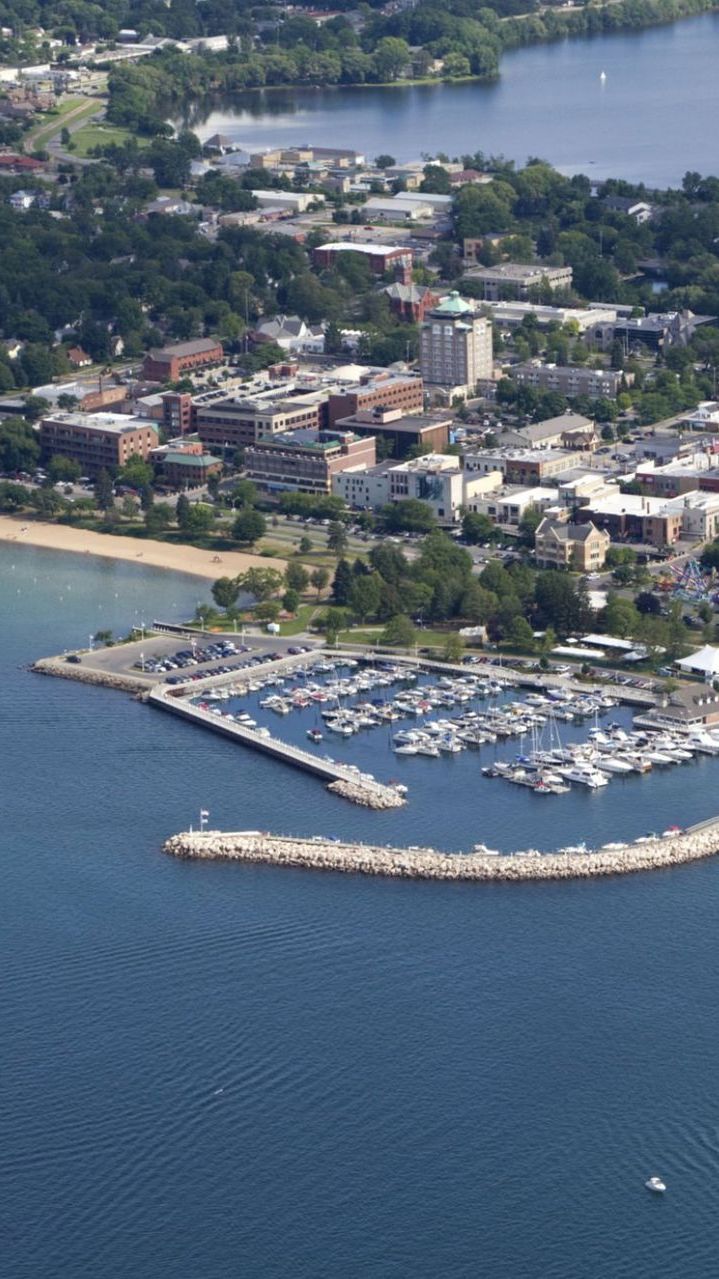 An aerial view of a city surrounded by water and boats