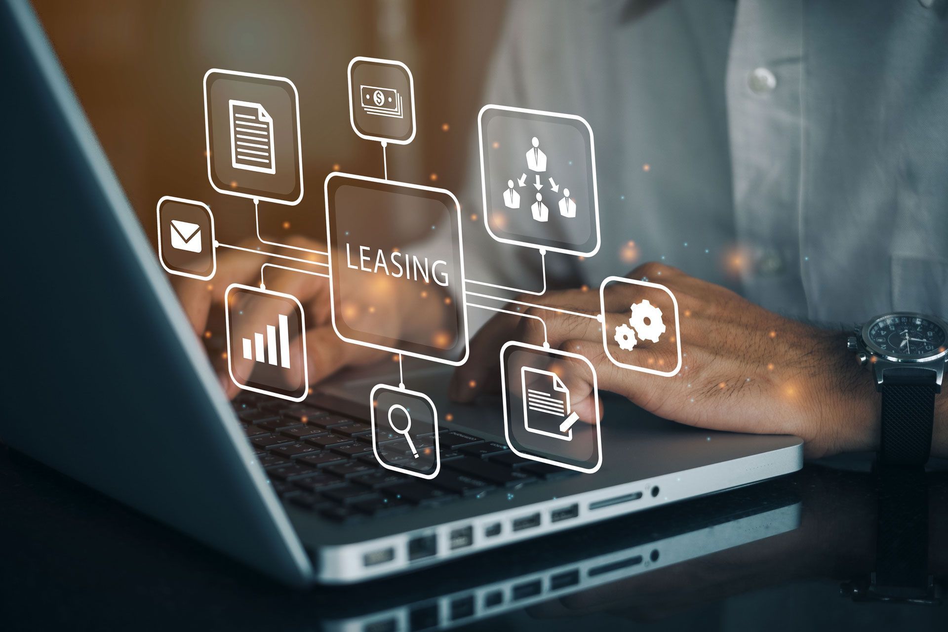 Hands typing on a laptop with floating digital business and analytics icons on screen