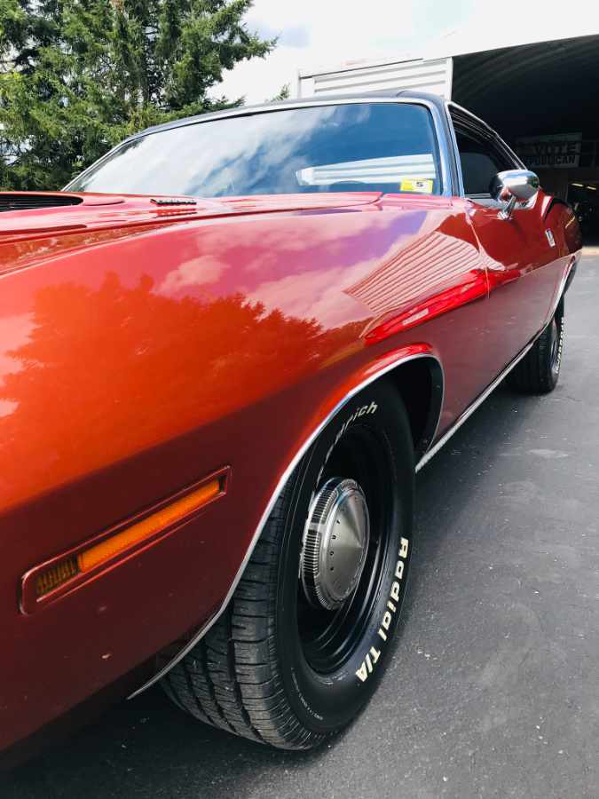 shiny brown cuda parked in a driveway