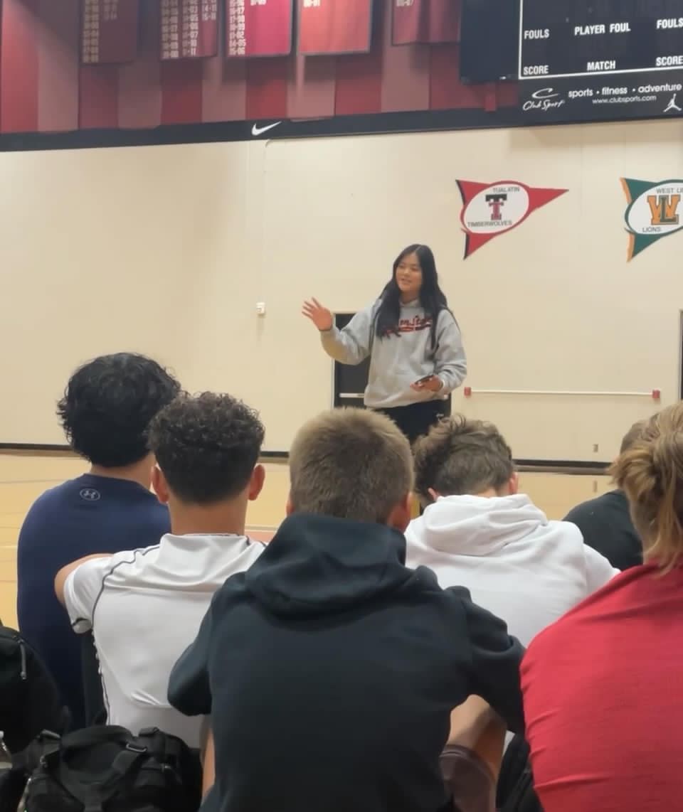 Young, female student leader speaking at an FCA Huddle