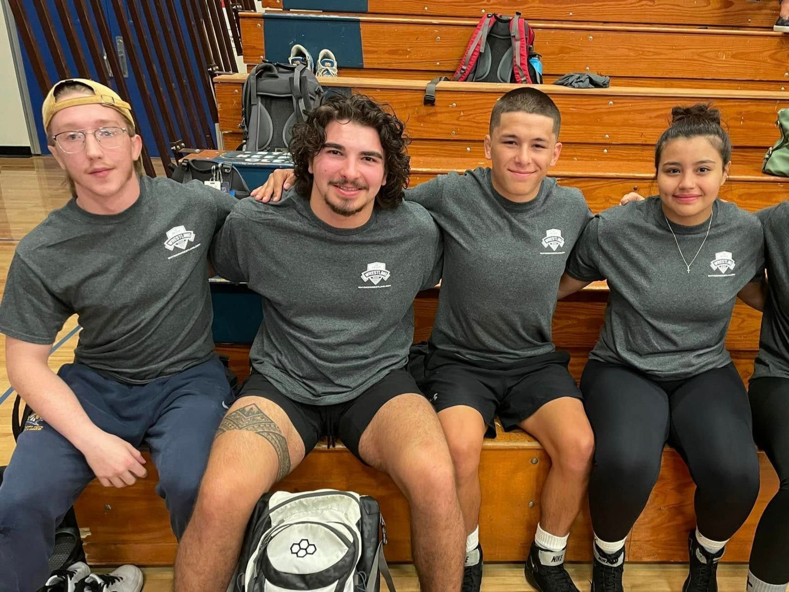 Lucien and other Wrestlers smiling at a Wrestling camp