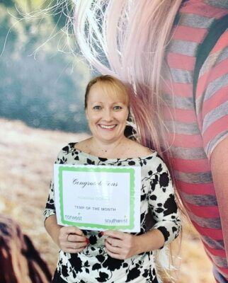A woman is holding a sign that says `` congratulations ''.