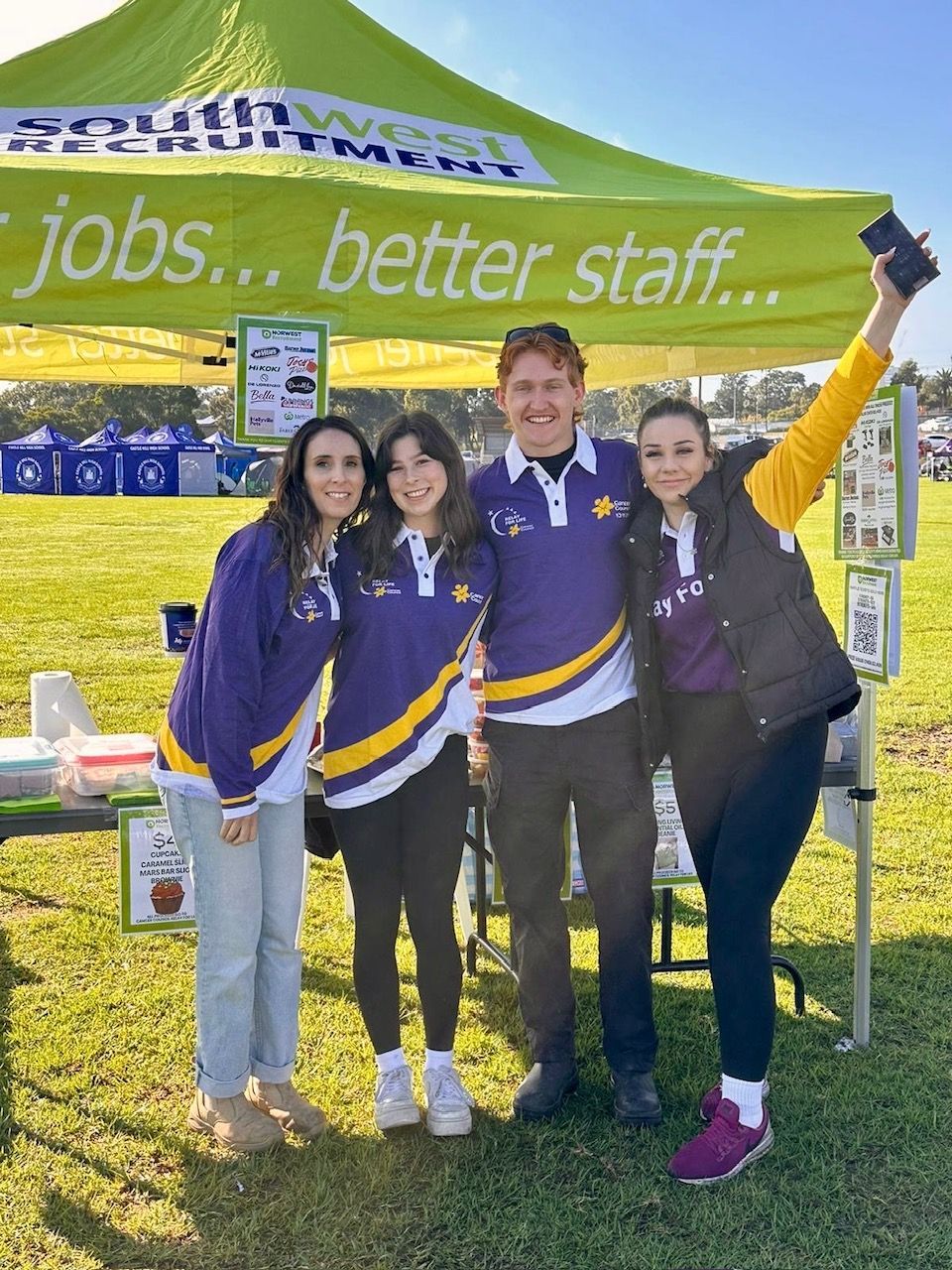A group of people are having a video call on a laptop.