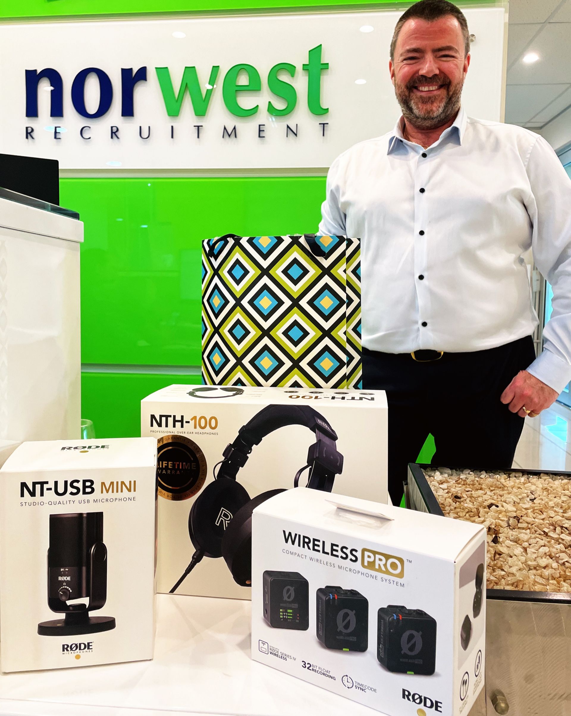 A group of people are sitting at a table holding glasses of wine.