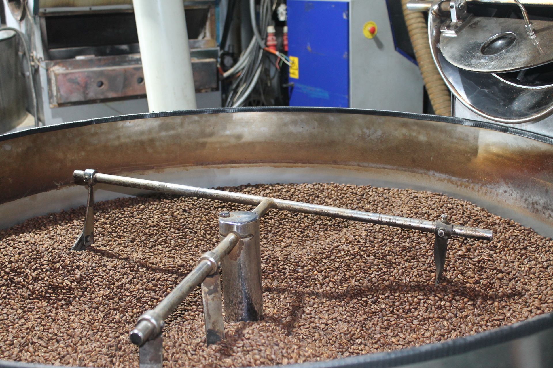 A large metal container filled with coffee beans