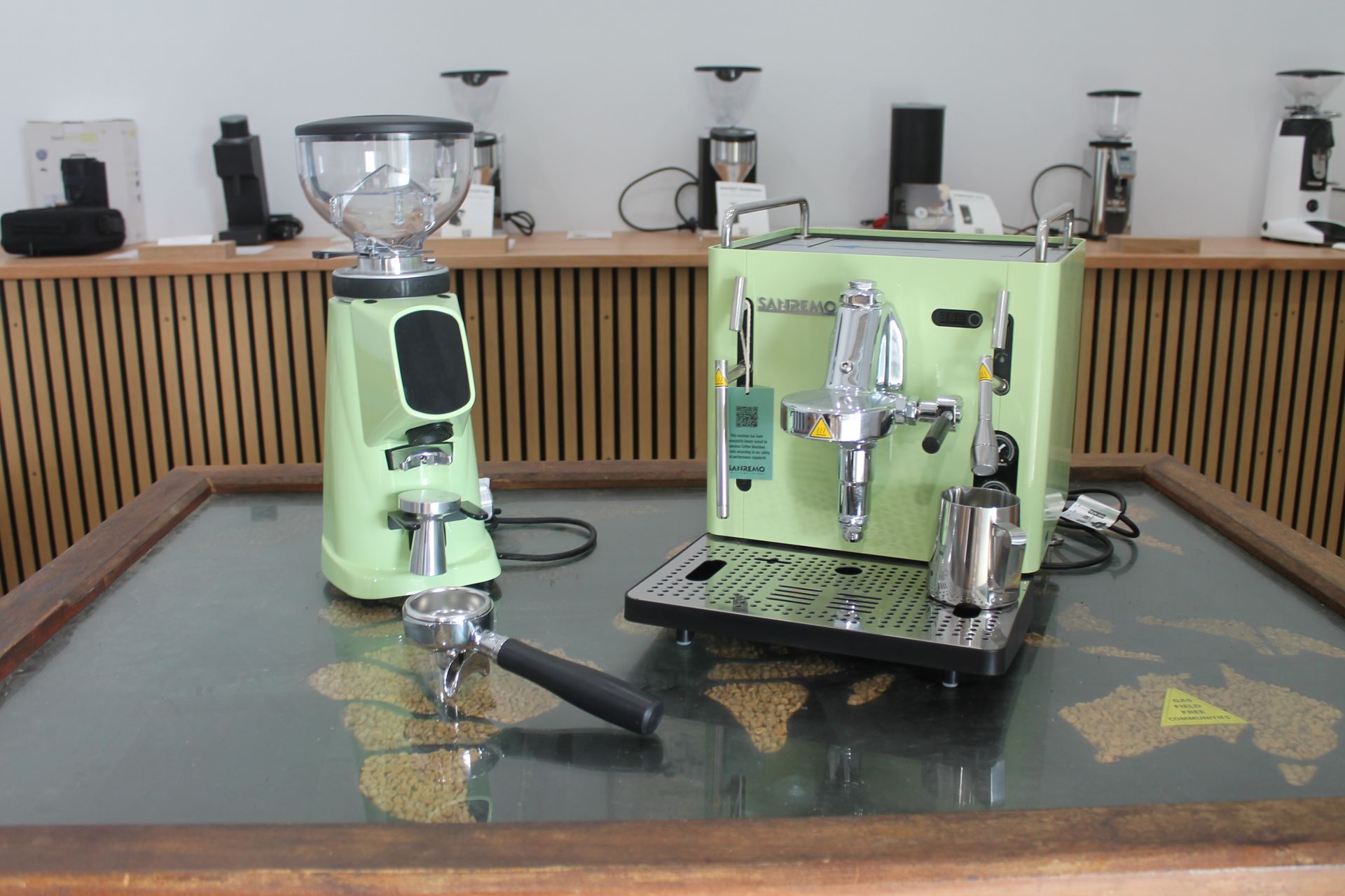 A Green Coffee Grinder and Machine on a Table — Nat’s Coffee in Alstonville, NSW