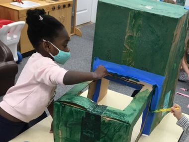 Kid Making a Cardboard Truck — Parsippany, NJ — Carousel Of Learning, Early Learning Center & Child Care
