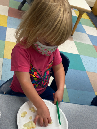 Kid Slicing Her Food — Parsippany, NJ — Carousel Of Learning, Early Learning Center & Child Care