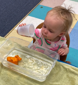 Infant Playing with Food — Parsippany, NJ — Carousel Of Learning, Early Learning Center & Child Care