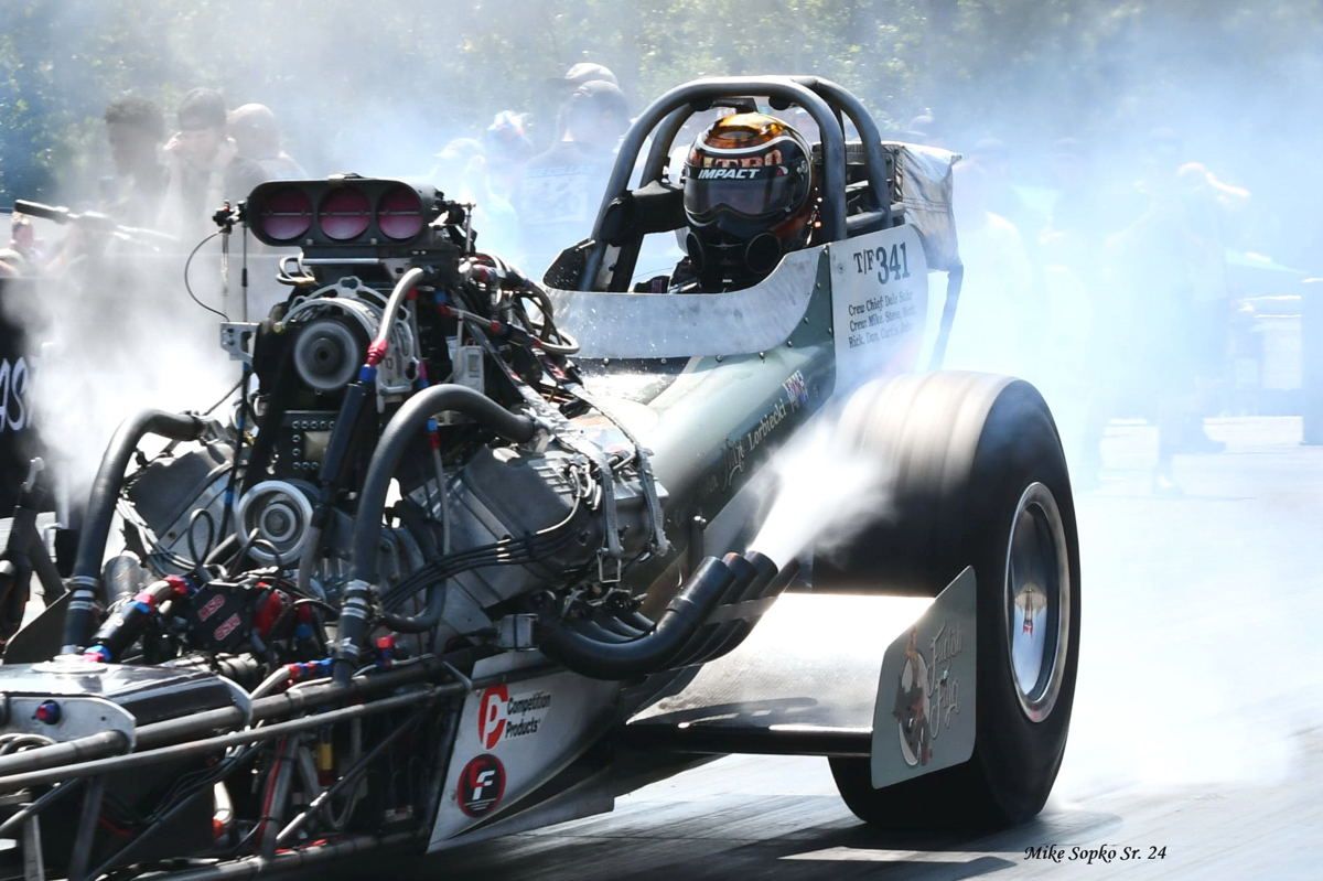 A man is driving a race car with the number 90 on the side