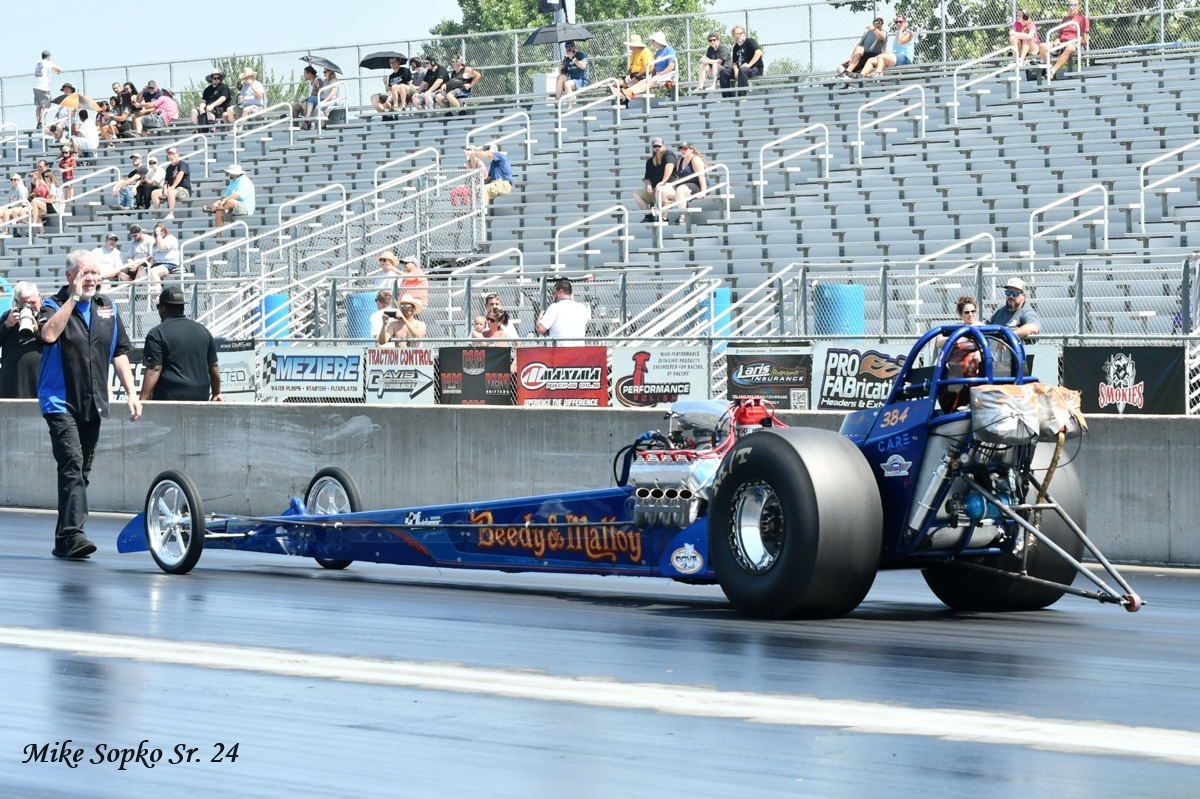 A drag racing car is on a race track