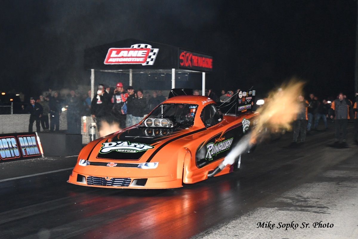 A race car with a flame coming out of the hood