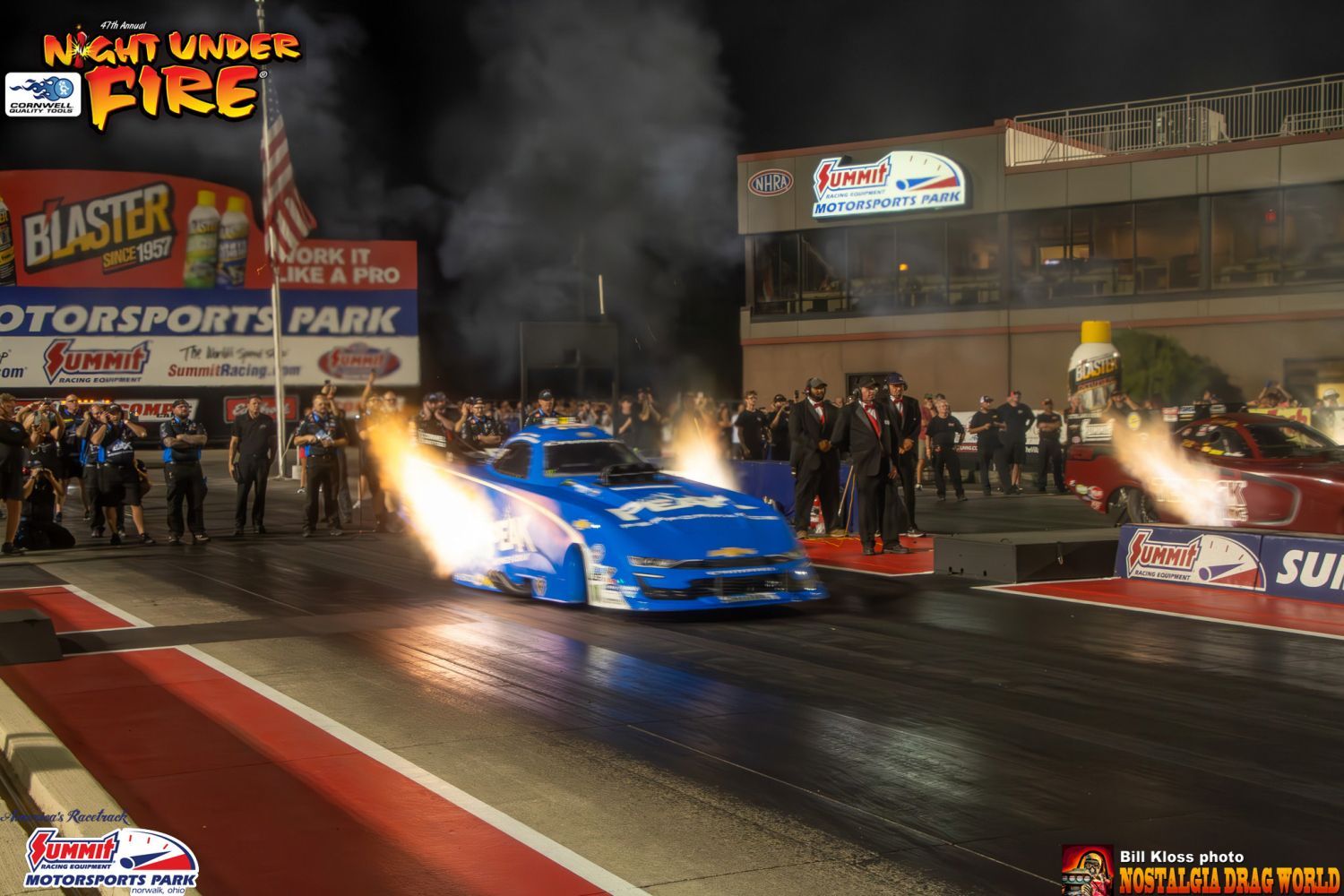 A drag race is taking place at night under fire