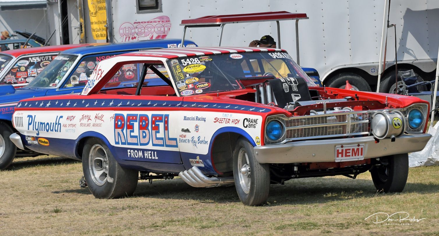 A red and white car with the word rebel on it