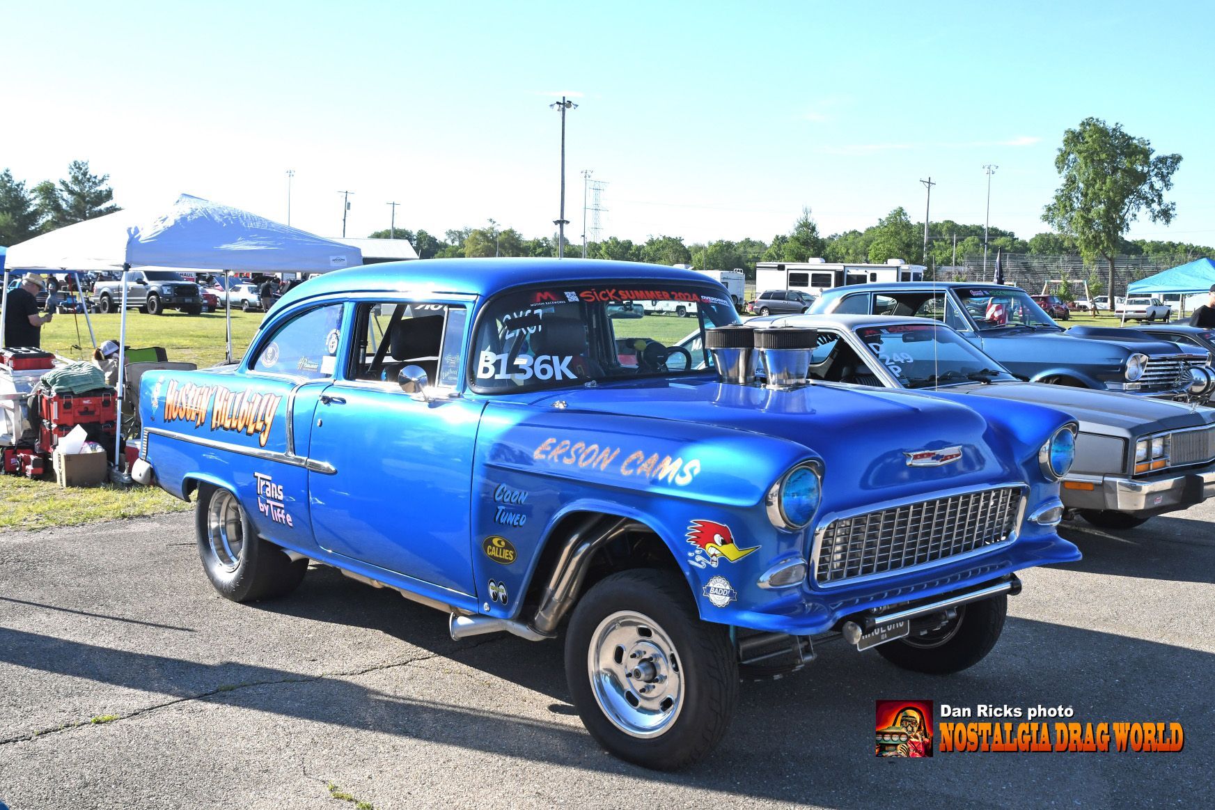 A blue car with a sticker on the windshield that says flash cars