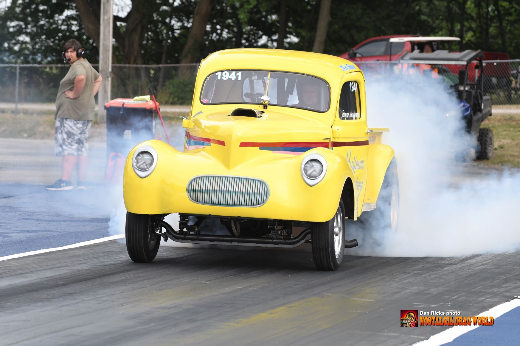 A yellow car with the number 1341 on the front of it