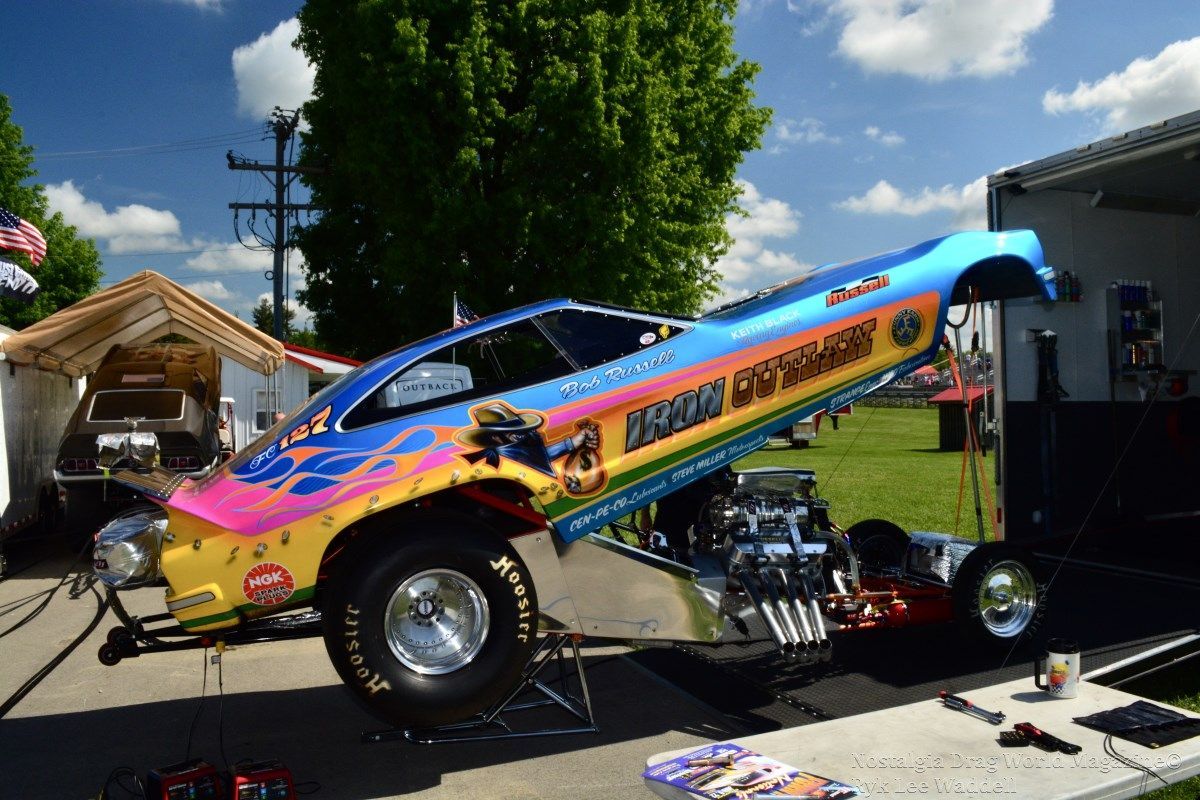A drag race car is sitting on top of a table.
