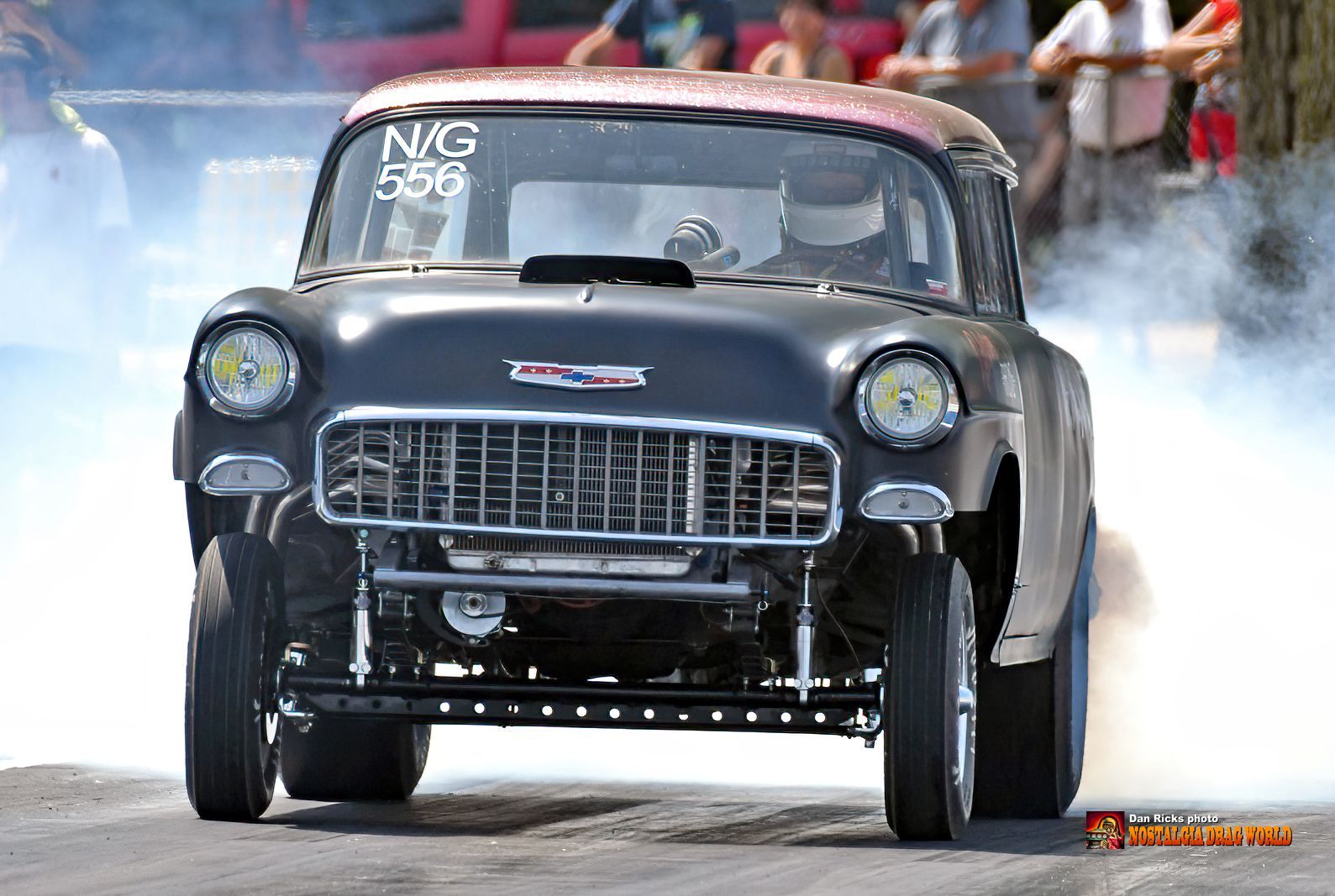 A black car with a license plate that says nmg 556