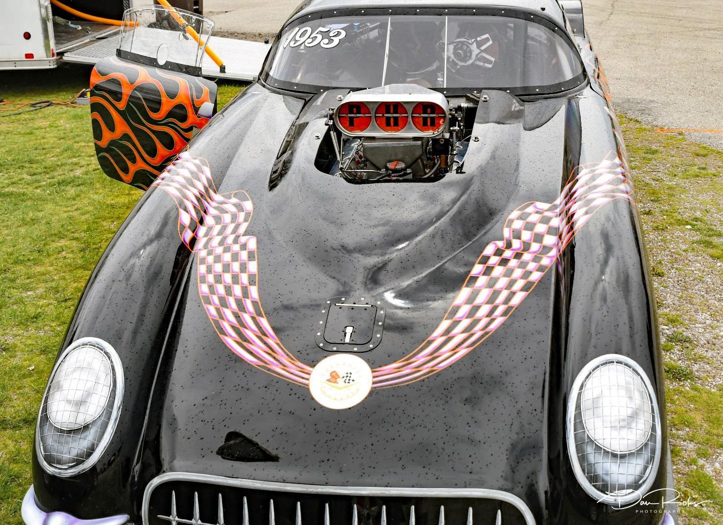 A black car with a checkered flag on the front