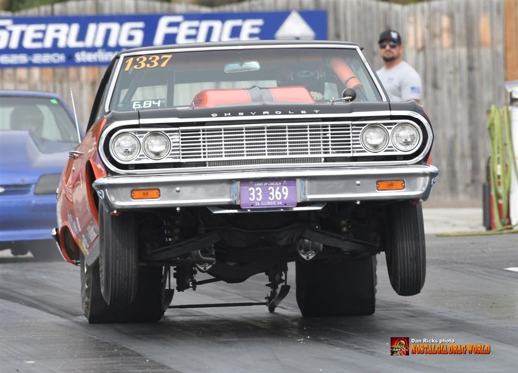 A sterling fence sign is behind a car