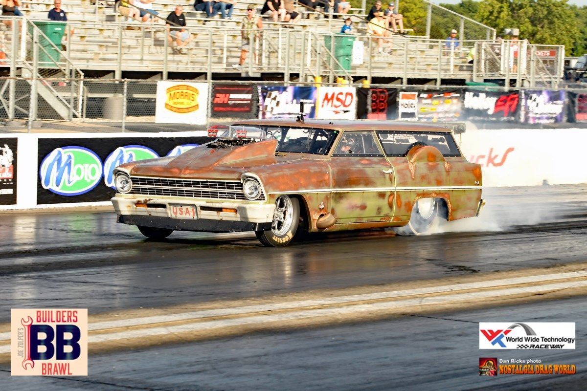 A rusty car is doing a burnout on a race track