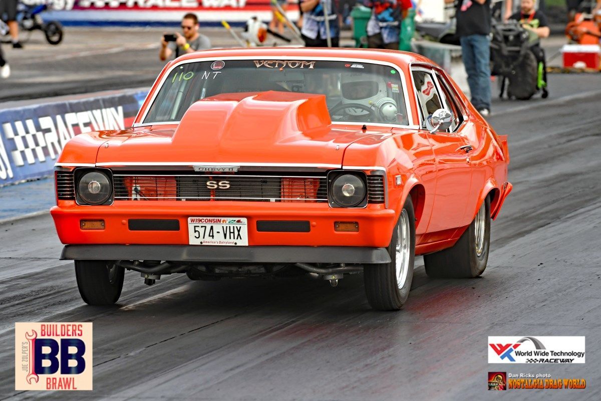 A red car with a license plate that says 574-1018