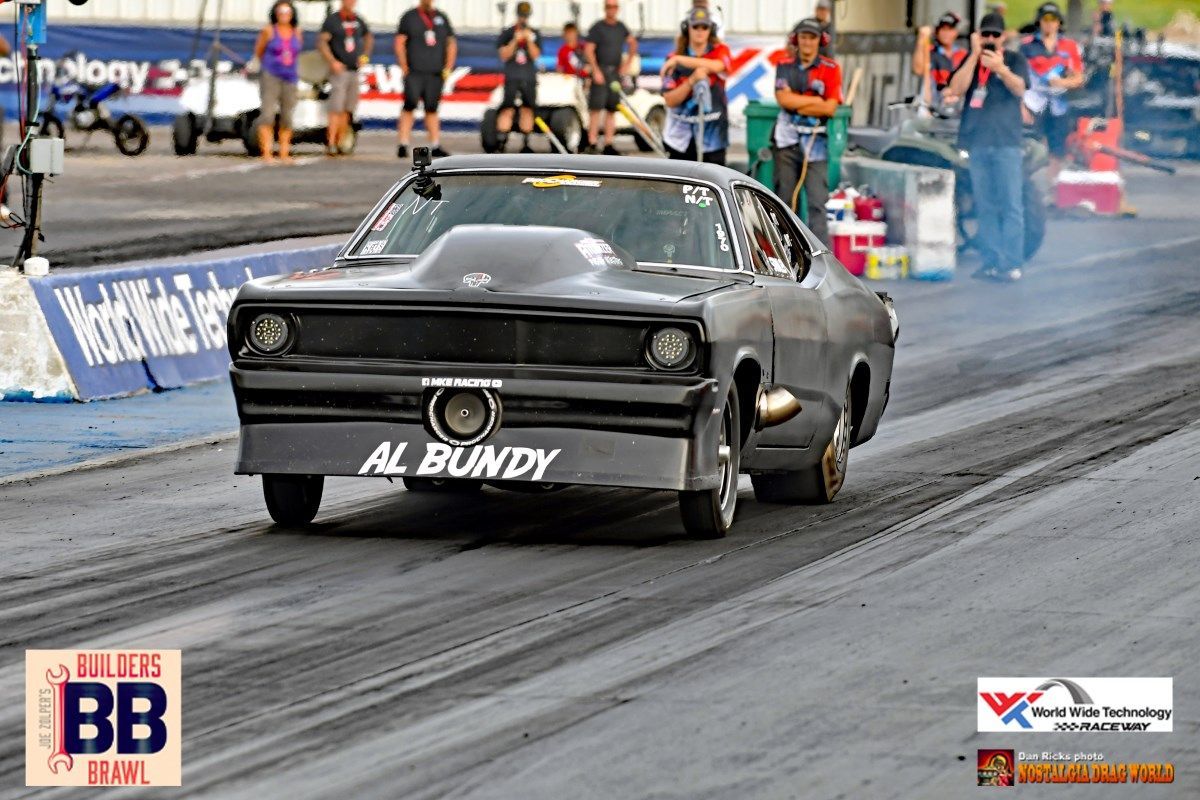 A car with the name al bundy on the side is driving down a race track
