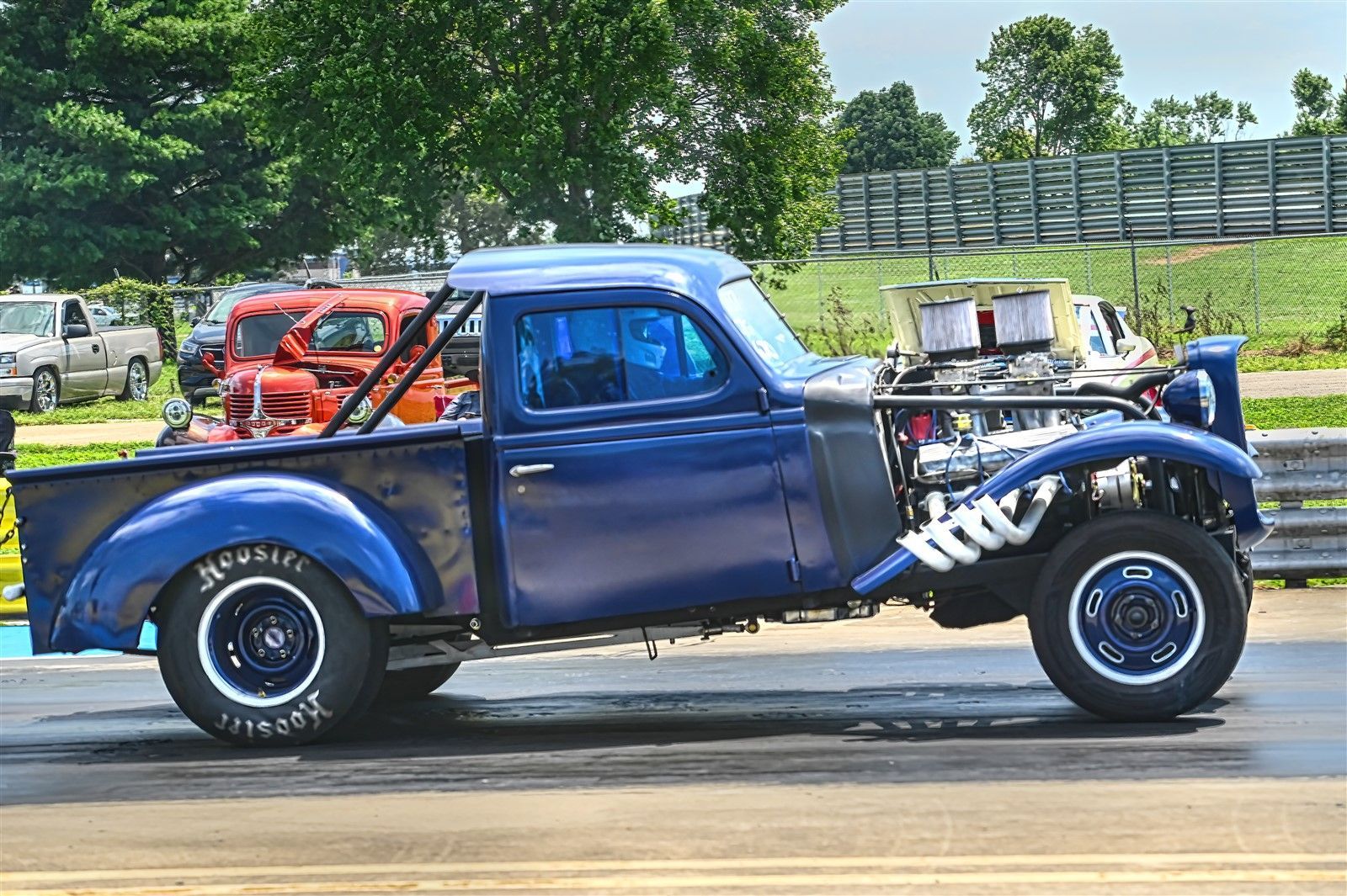 A man is sitting in the driver 's seat of a race car.